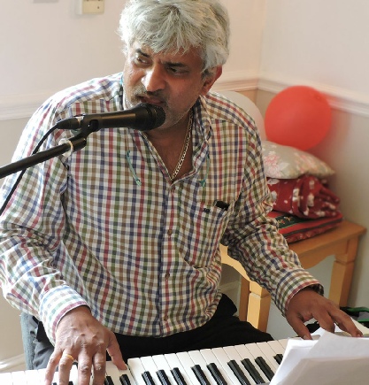 Image showing musician playing piano for stimulating and fun activities in Care Home